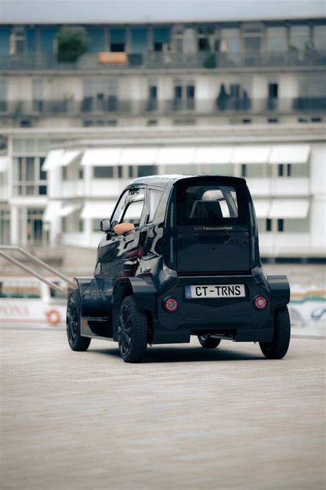 electric microcar retracts wheels to easily park and .